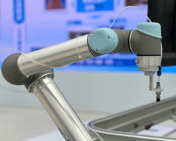 Detailed close-up of a modern industrial robotic arm in a manufacturing setting.